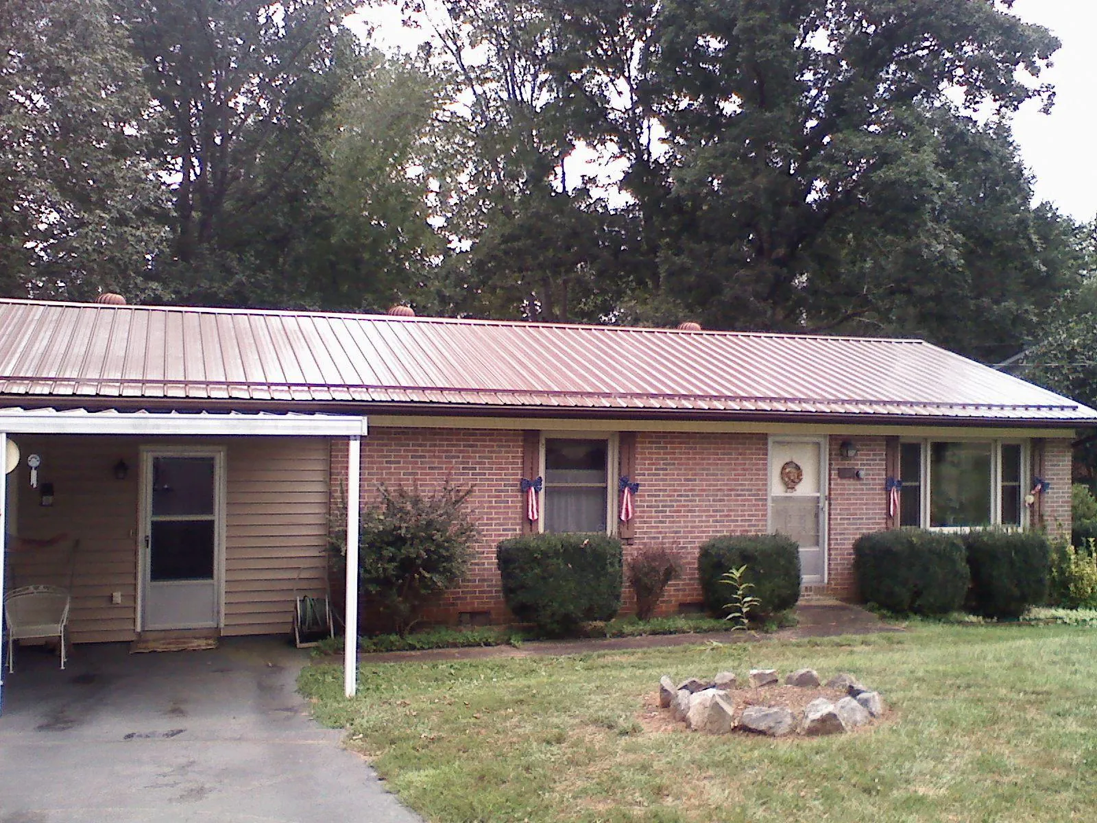 Bronze metal roof and carport on a brick ranch home — Roof Repair work by our crew in Troutdale